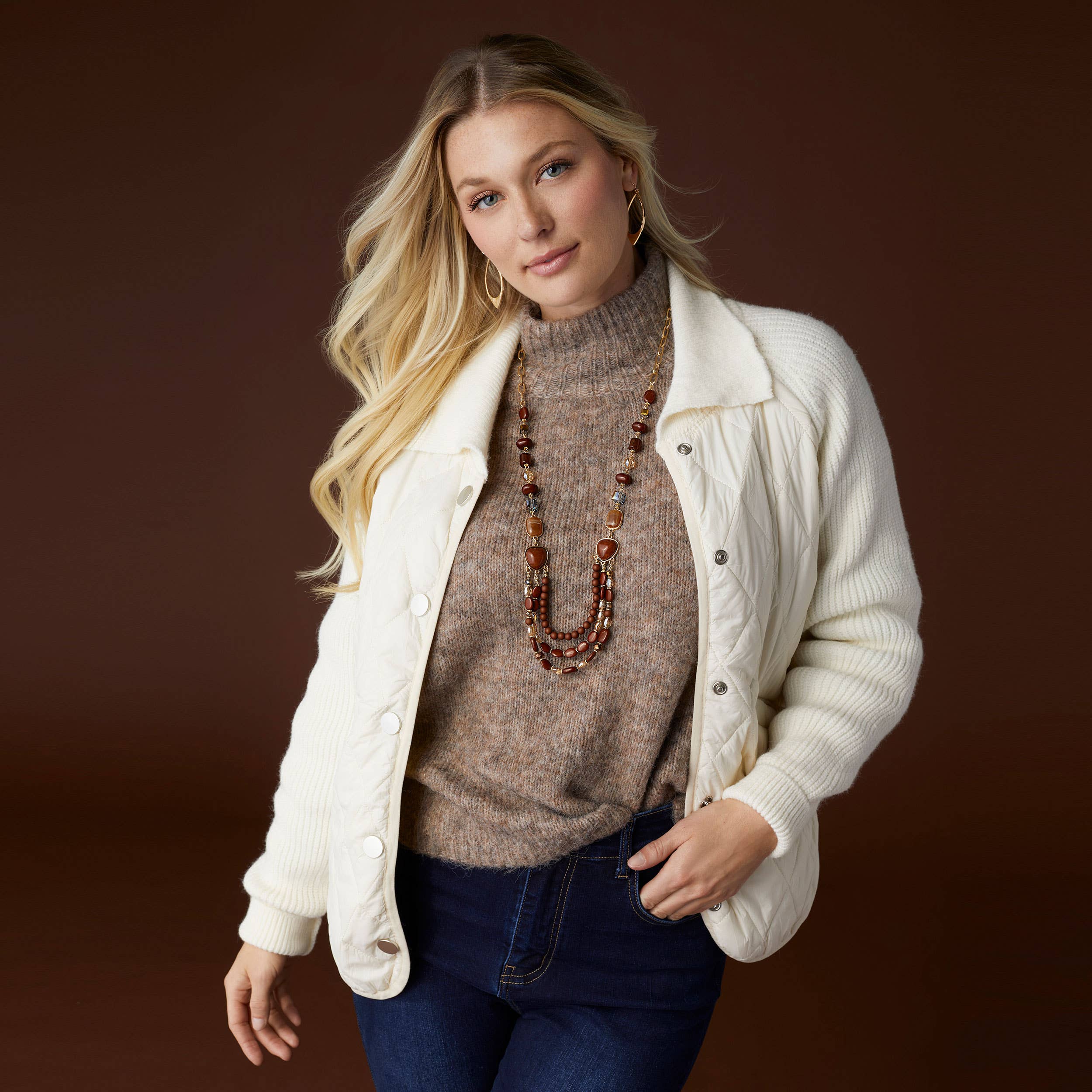 Woman wearing Latte Heather Kayne mohair sweater with white jacket and jeans