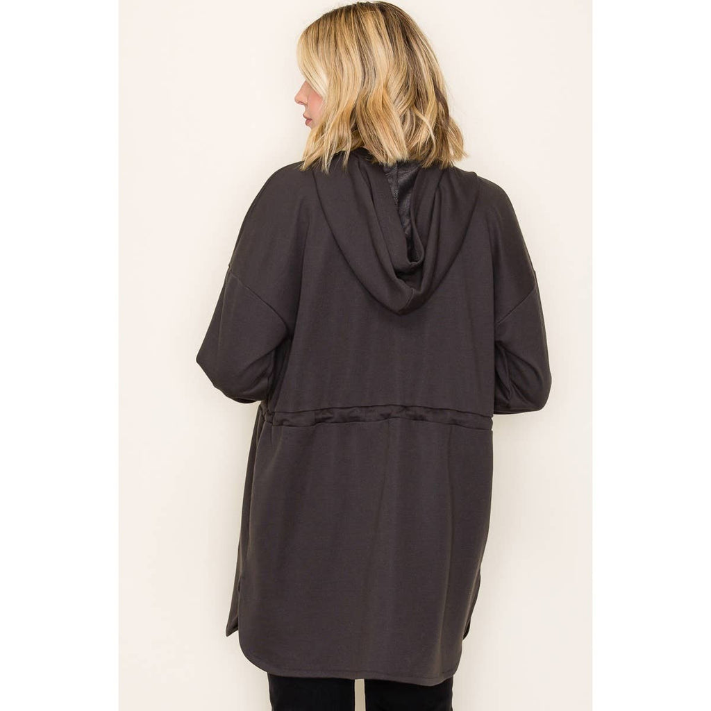 Woman wearing black French terry duster hoodie jacket with drawstring waist and long sleeves, back view