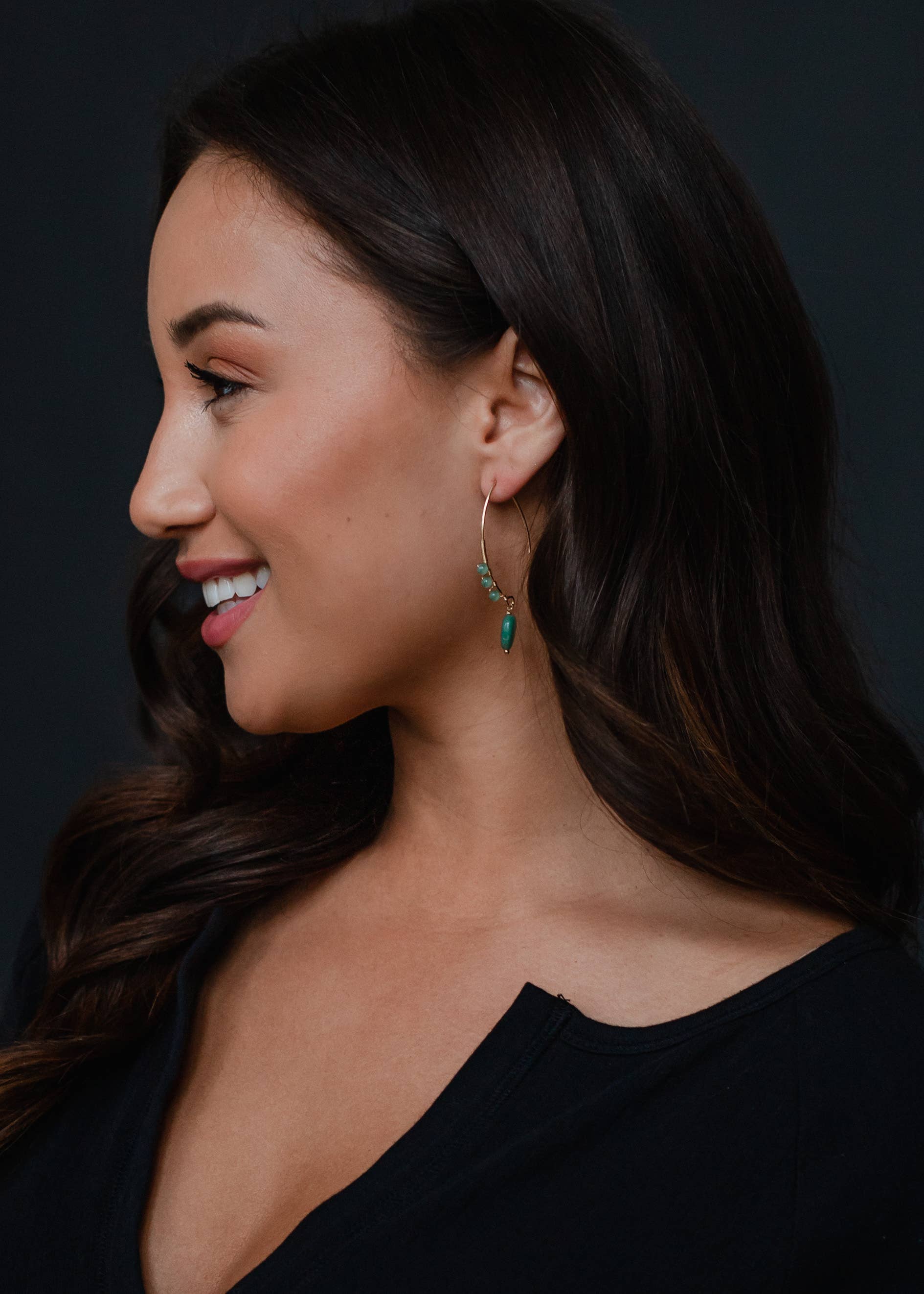 Woman wearing beaded dangles earrings with gold detail, 2-inch length, lead and nickel free