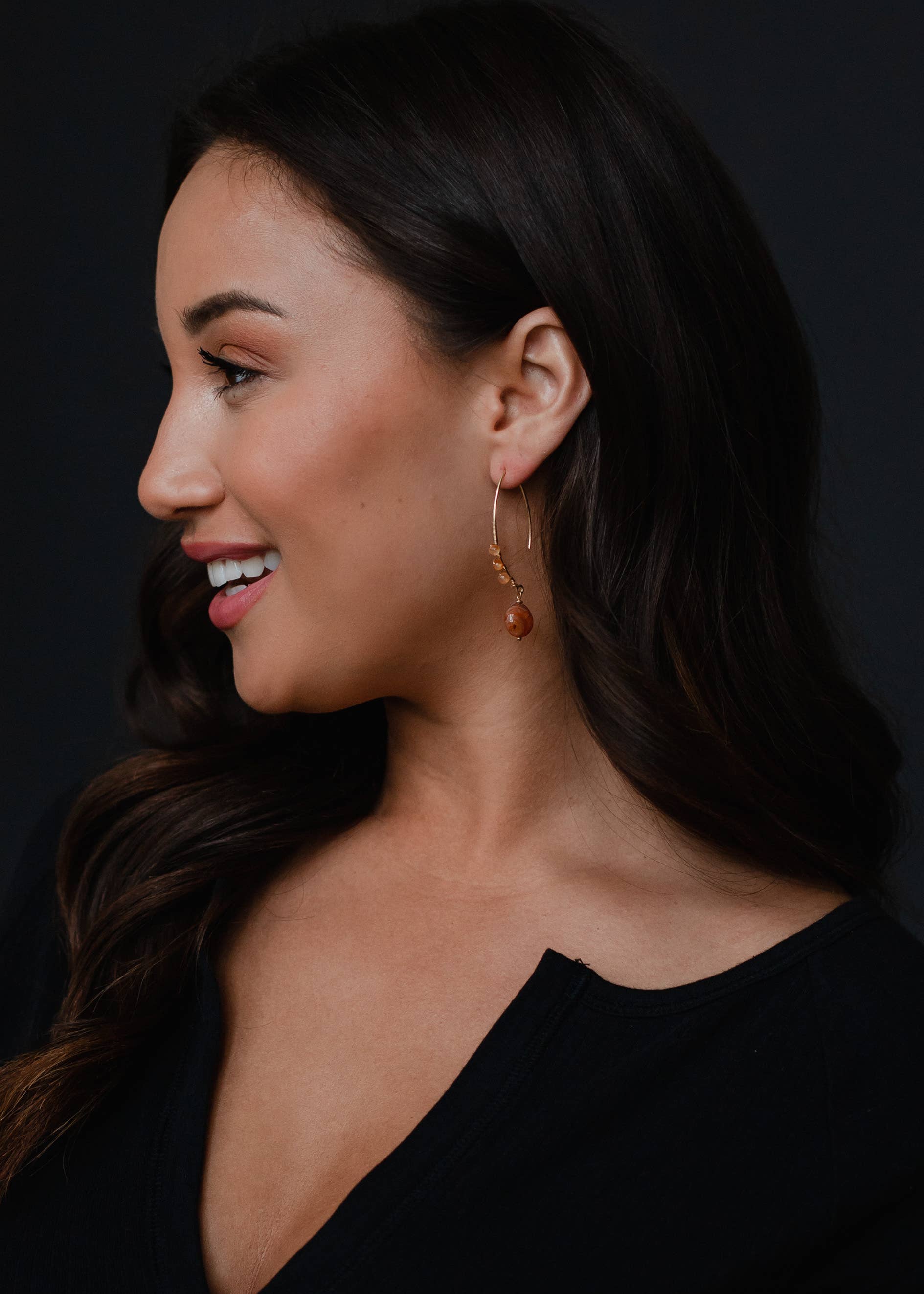 Woman wearing gold detail 2-inch beaded dangles earrings, lead and nickel free