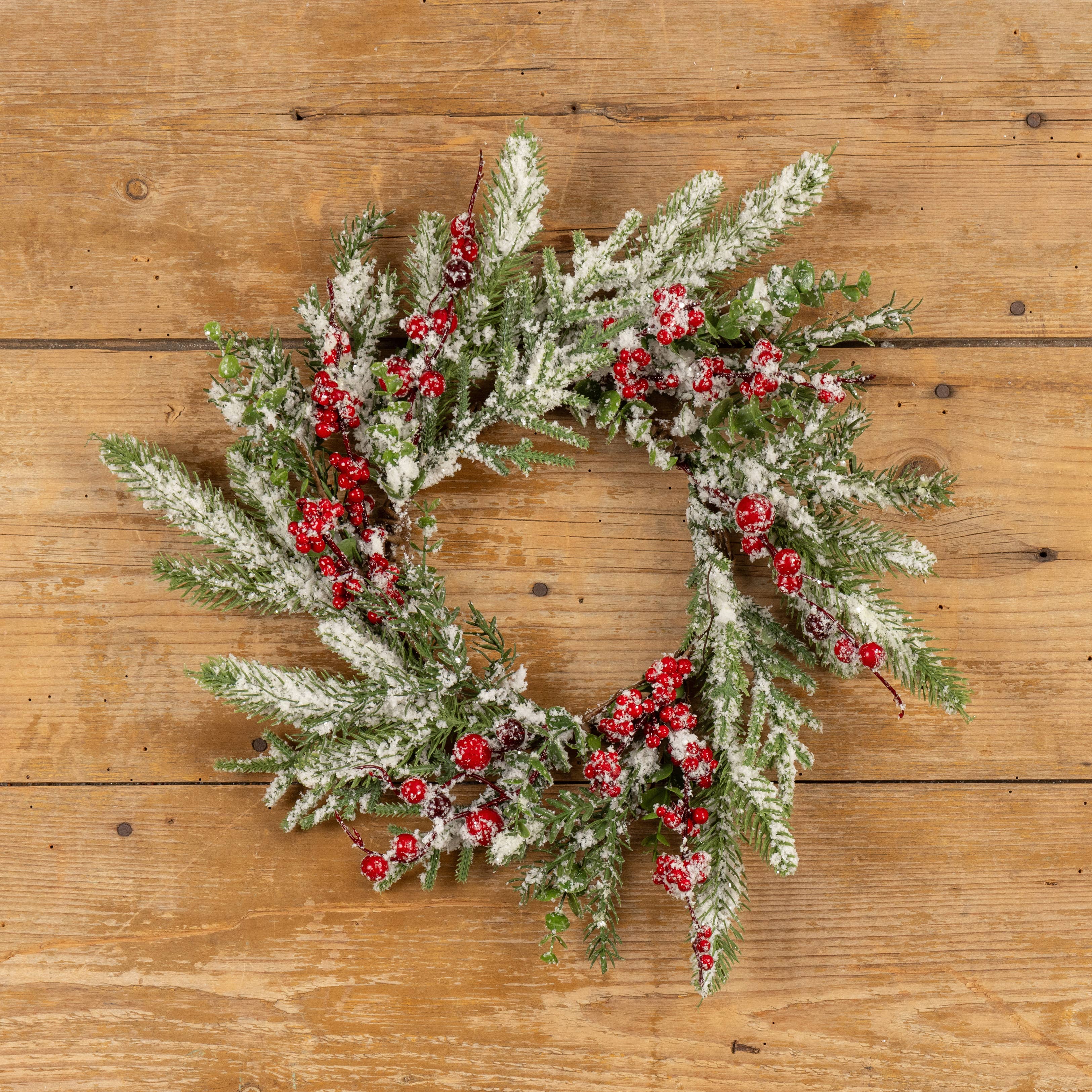 Ragon House 16-inch snowy evergreen wreath with red berries on wooden background