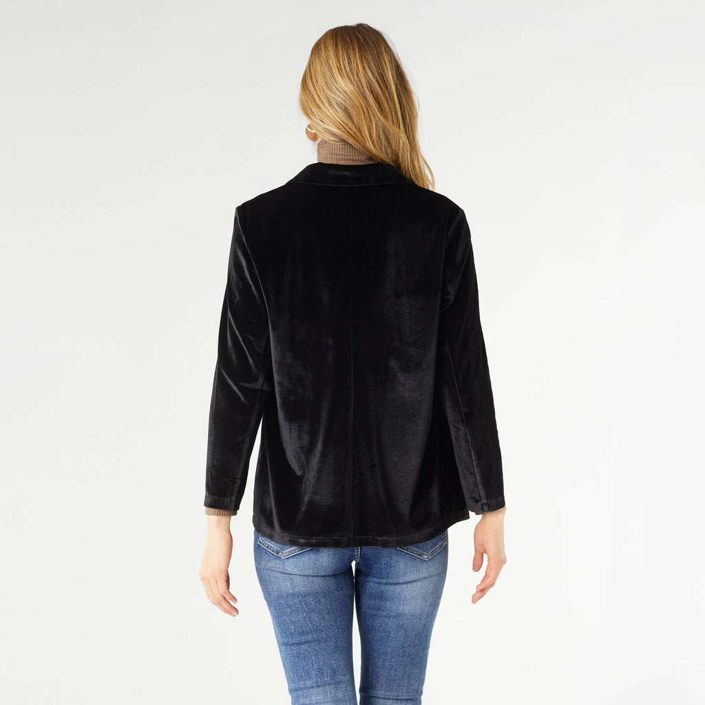 Woman wearing black Penny velour cardigan with long sleeves, shown from back