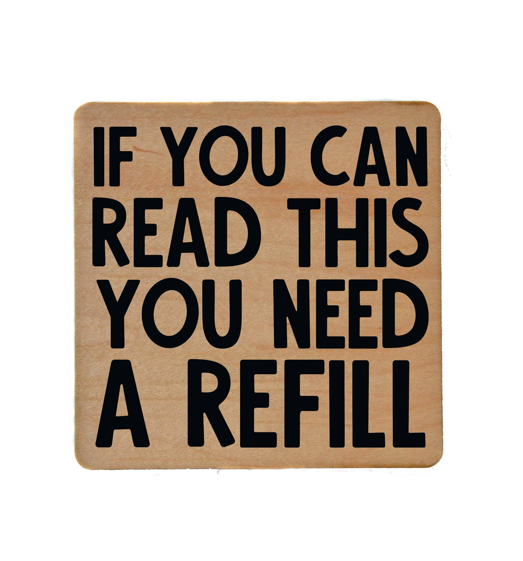 Wooden bar coaster with "If You Can Read This You Need A Refill" text and cork backing