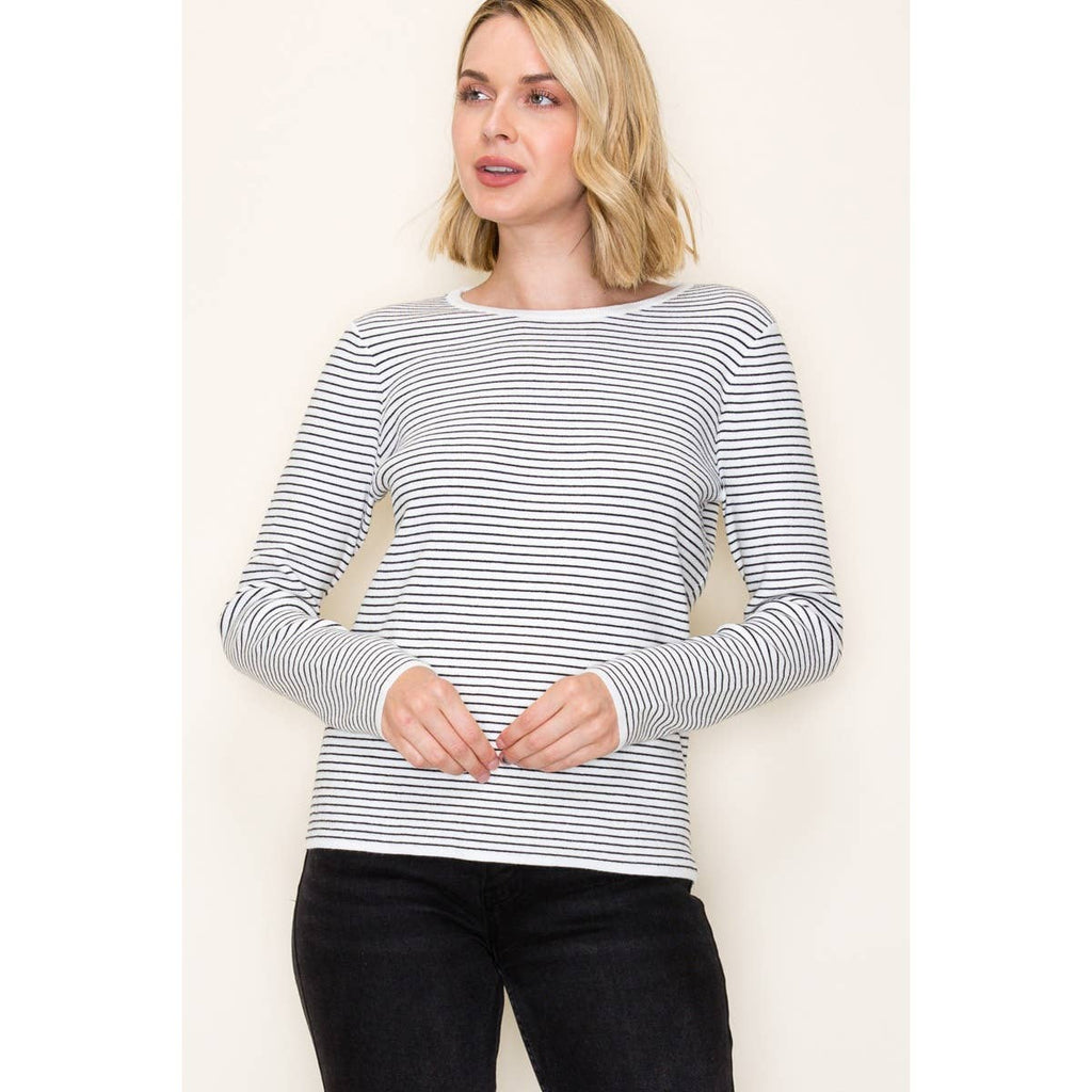 Woman wearing ivory and taupe long sleeve pinstripe top with crew neckline and relaxed fit