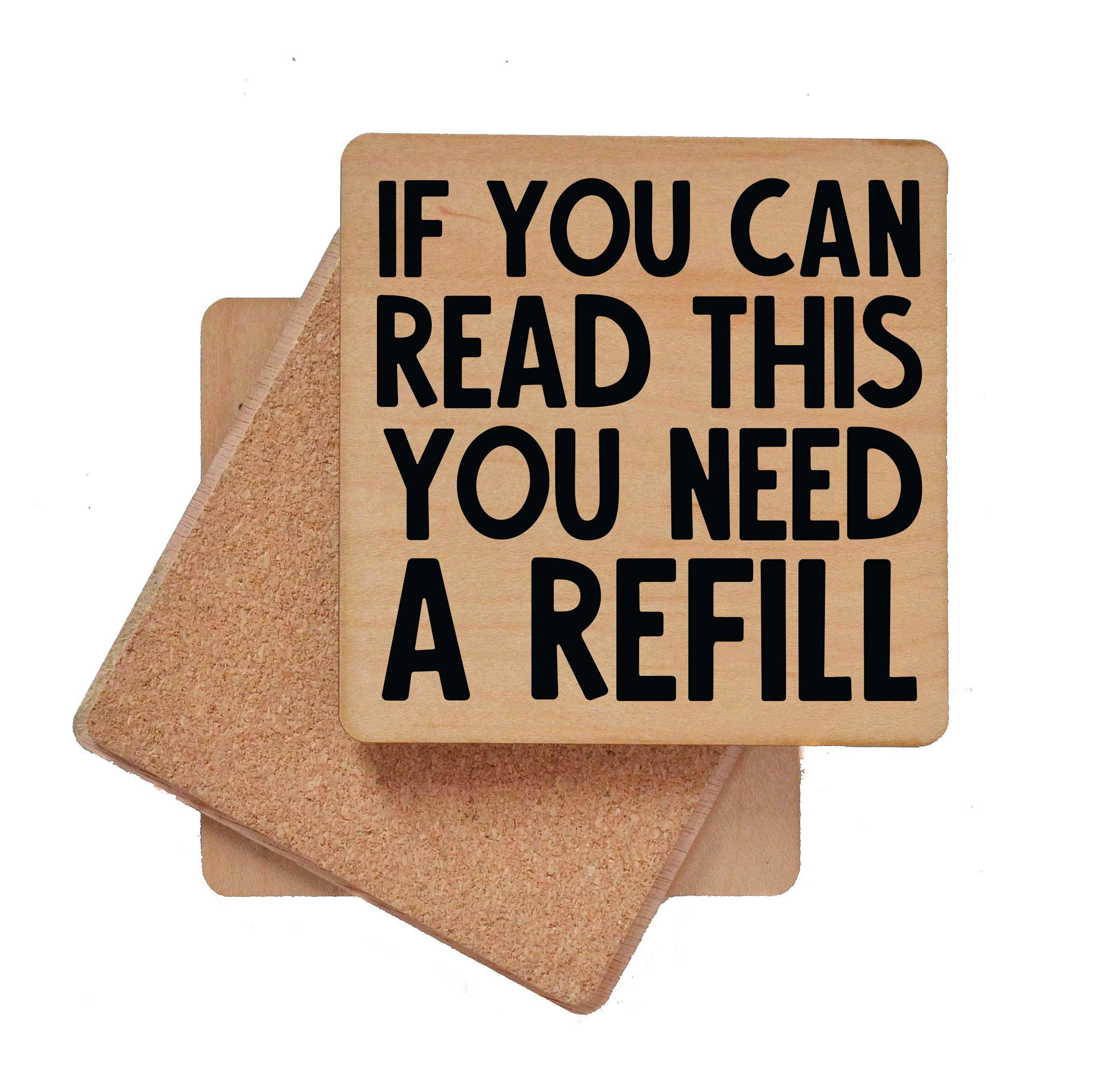 Wooden bar coaster with "If You Can Read This You Need A Refill" text and cork backing