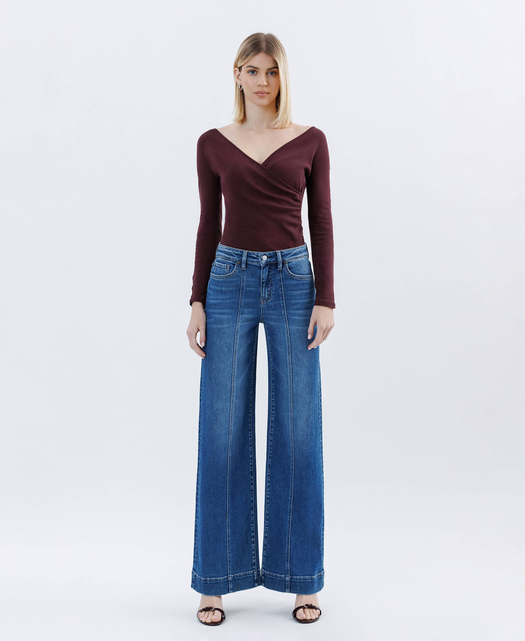 Woman wearing high rise Wide Leg Jeans trouser wide leg pleated blue jeans and maroon top