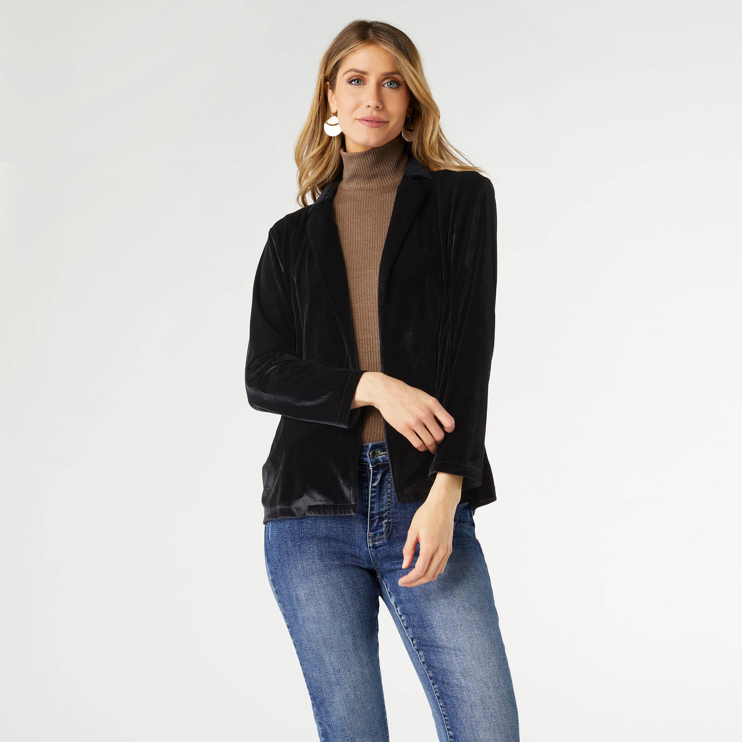 Black Penny Velour Cardigan with long sleeves and open front, styled over a brown turtleneck and jeans