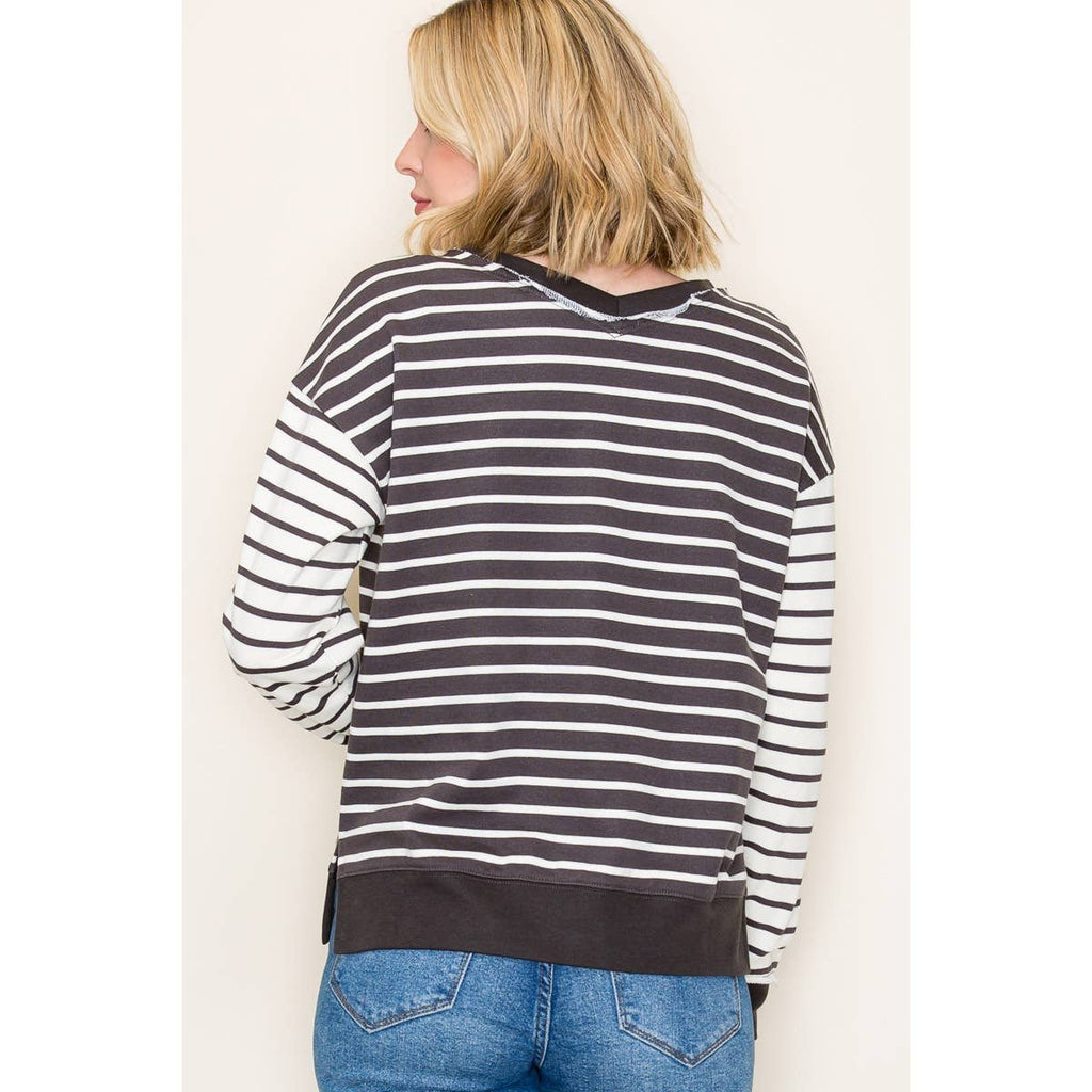 Back view of French terry long sleeve V-neck striped top in brown and white color-block stripes worn with jeans