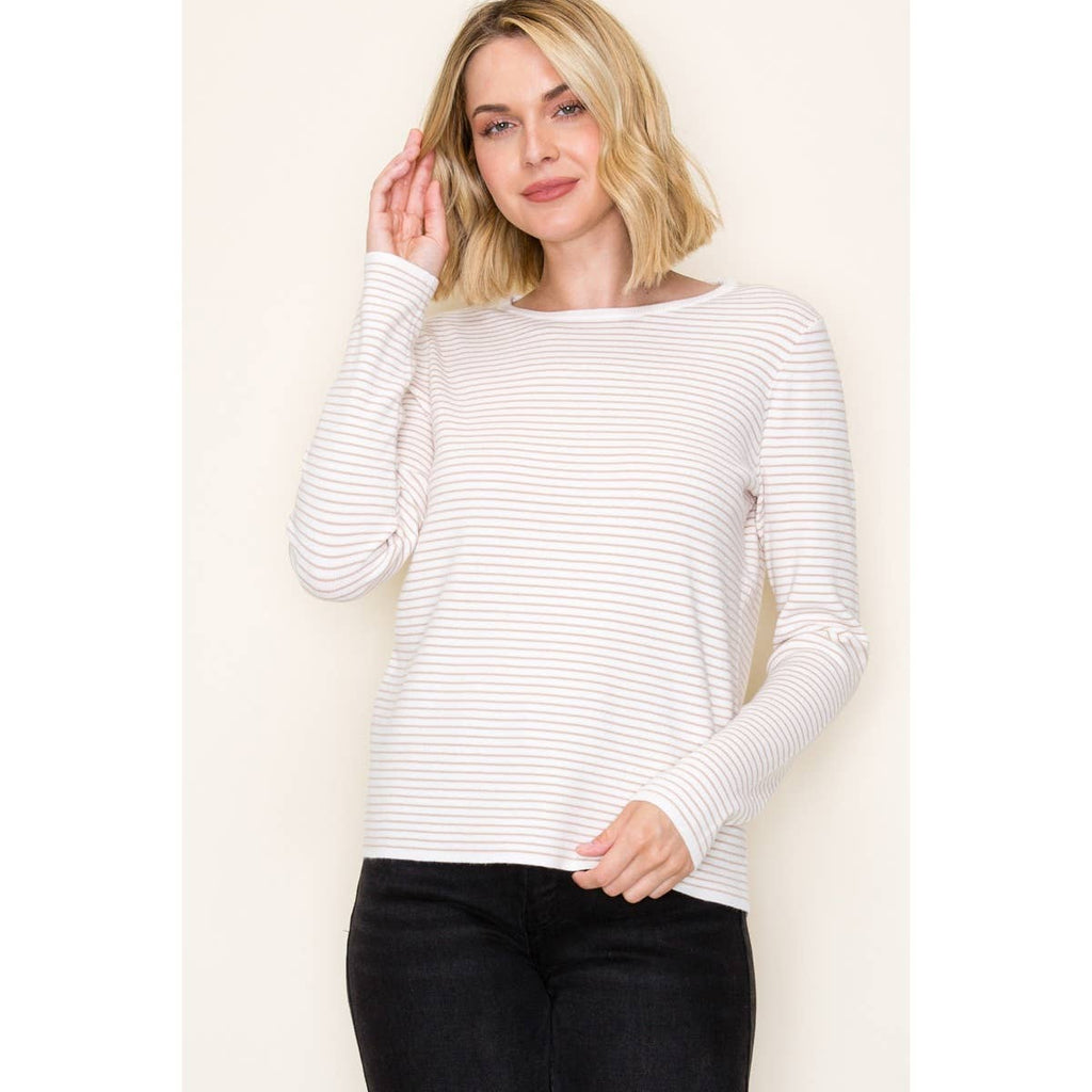 Woman wearing ivory and taupe long sleeve pinstripe top with crew neckline in soft knit fabric