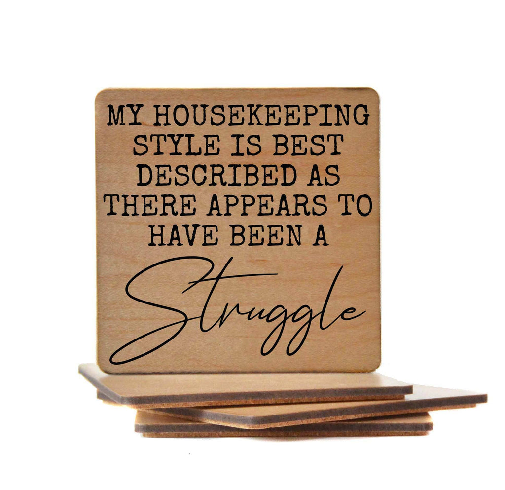 Funny wooden coaster with cork backing featuring the humorous quote "My housekeeping style is best described as there appears to have been a struggle"